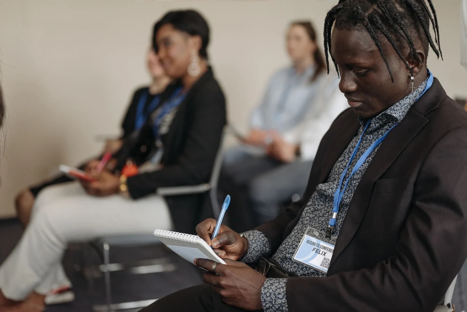 People at a seminar taking notes