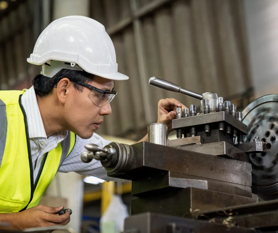 Engineer in a hard hat inspecting machinery at Serenity Impex.