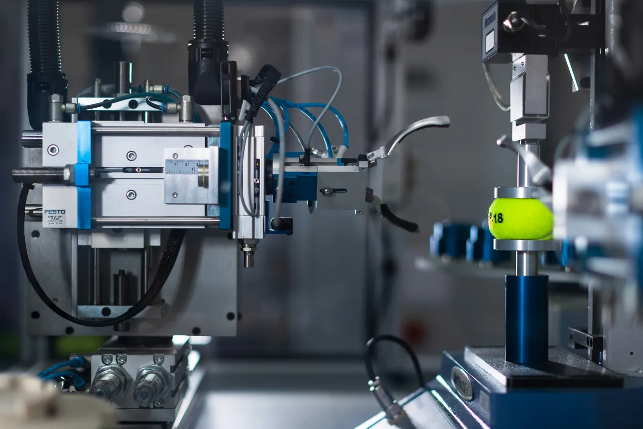 Automated machinery processing a yellow object.