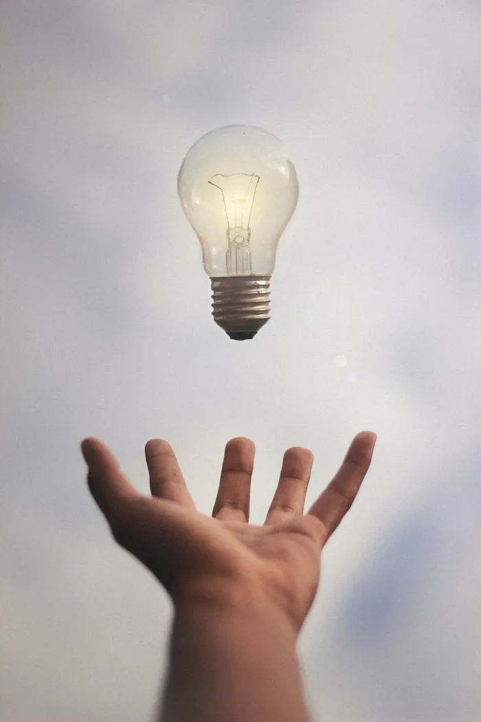 Light bulb above an open hand